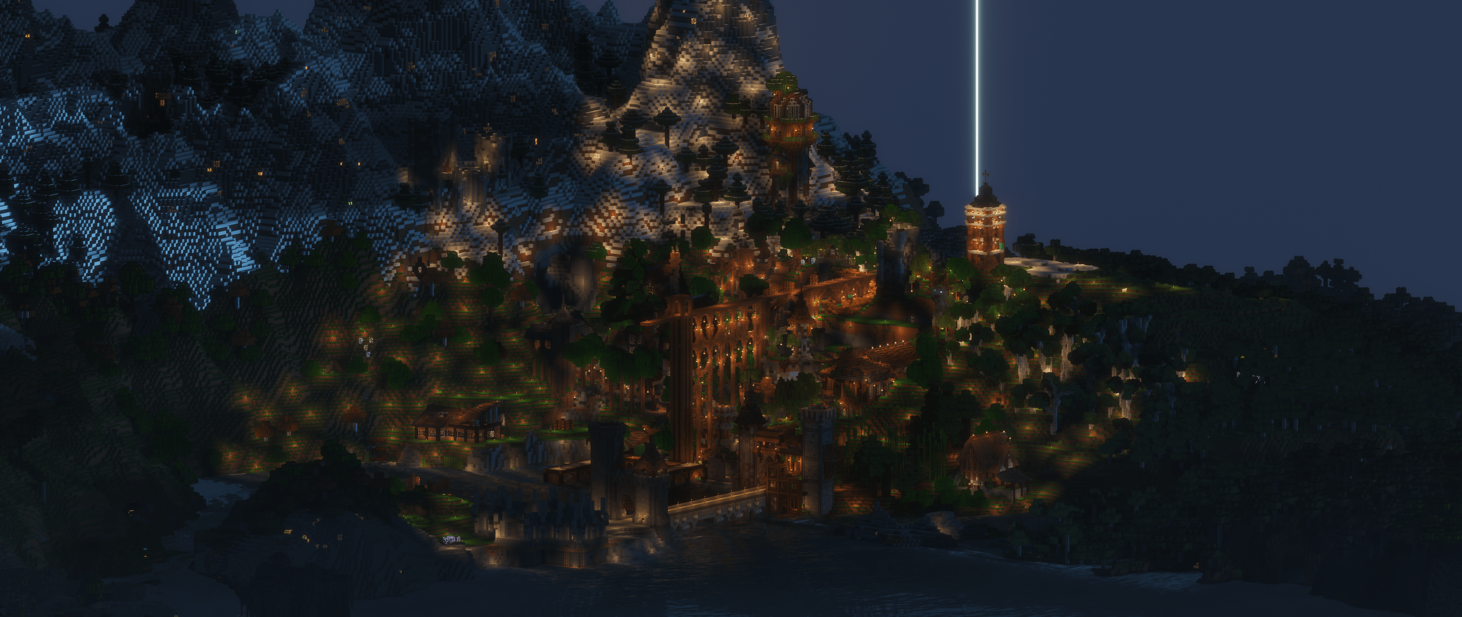 Wide aerial night view of the city and surrounding terrain